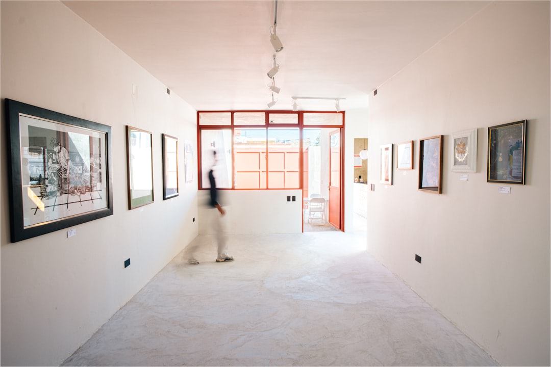 Gallery wall visual reference — framed exhibition displays in warm light